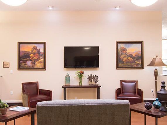 A cozy living room with modern furniture and decorative artwork.