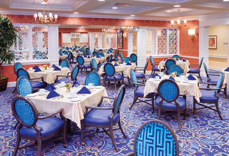 An elegant restaurant dining room with blue-themed decor and neatly arranged tables.