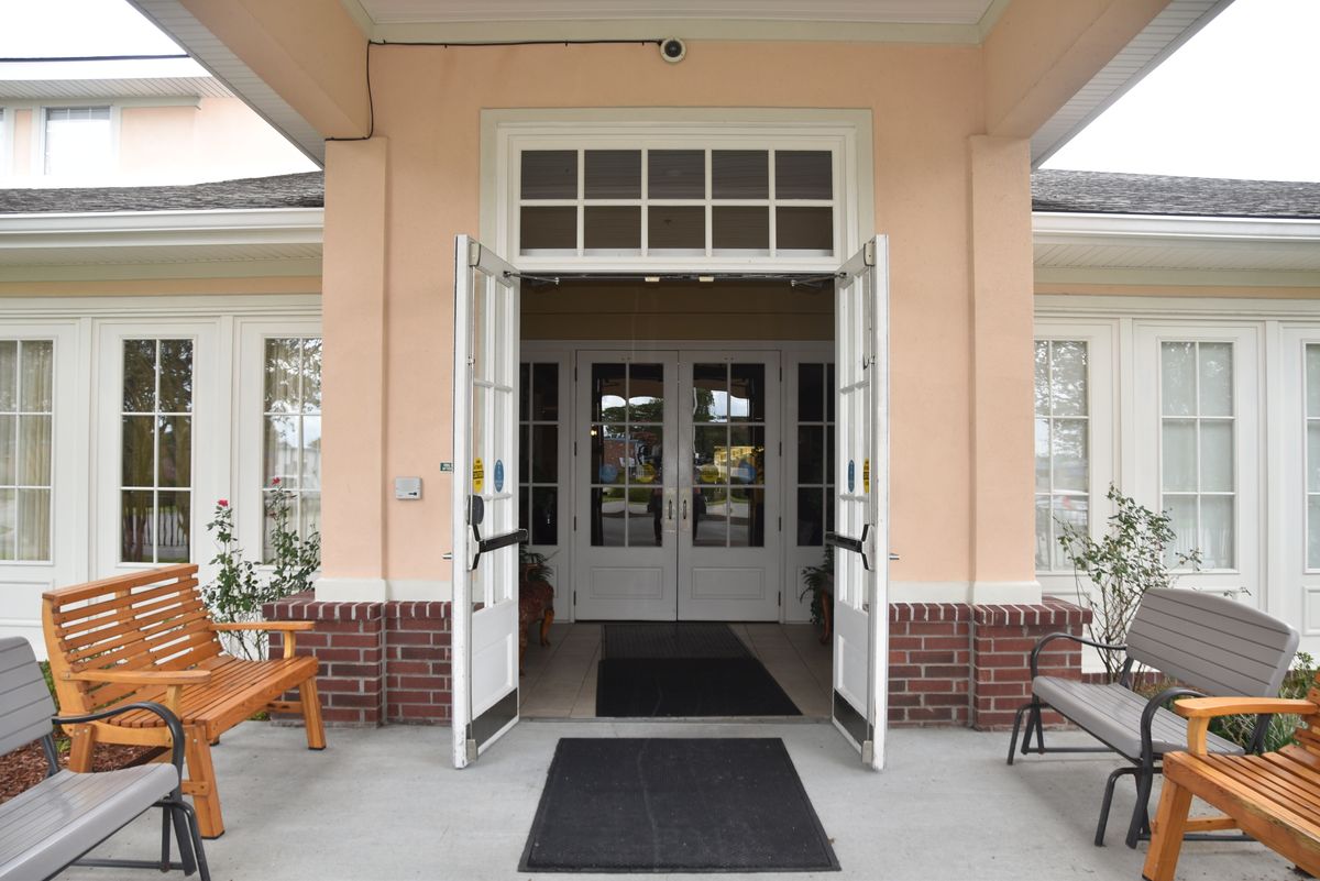 An inviting entrance with open double doors leading into a building.