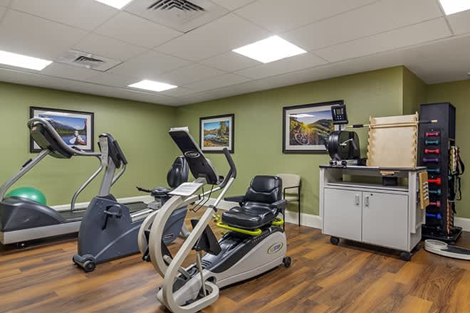 A small gym room featuring stationary bikes and fitness equipment.
