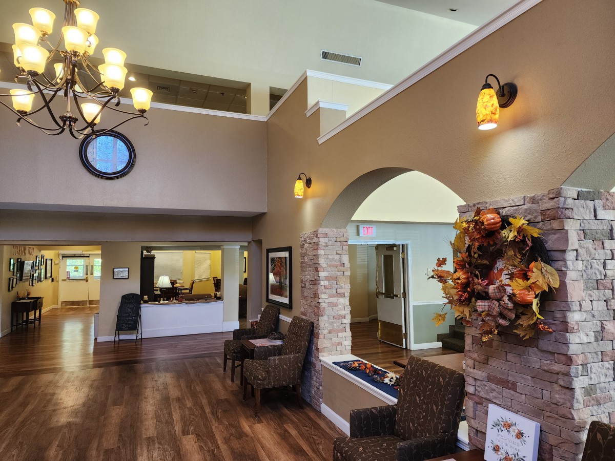 A spacious lobby area featuring seating, warm lighting, and seasonal decorations.