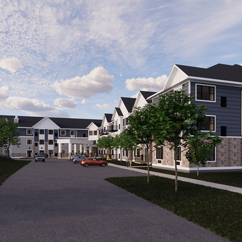 A modern residential building featuring multiple units and landscaped surroundings.
