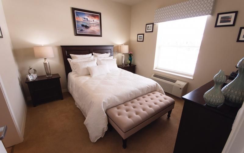 A cozy and elegantly decorated bedroom with a plush bed and soft lighting.
