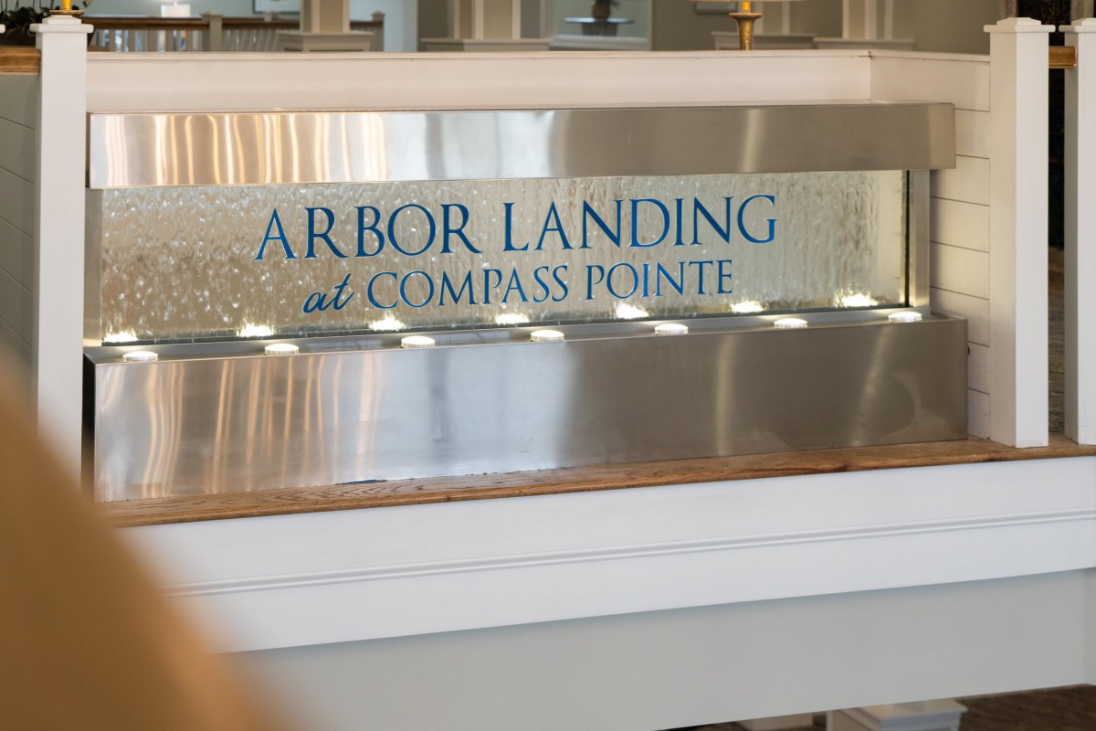 A sign inside the building labeled 'Arbor Landing at Compass Pointe'.