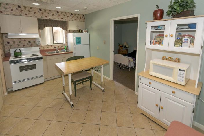 A cozy kitchen with a dining table and various appliances.