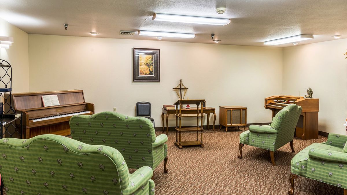 A retro-style living room with vintage furniture and green upholstered seating.