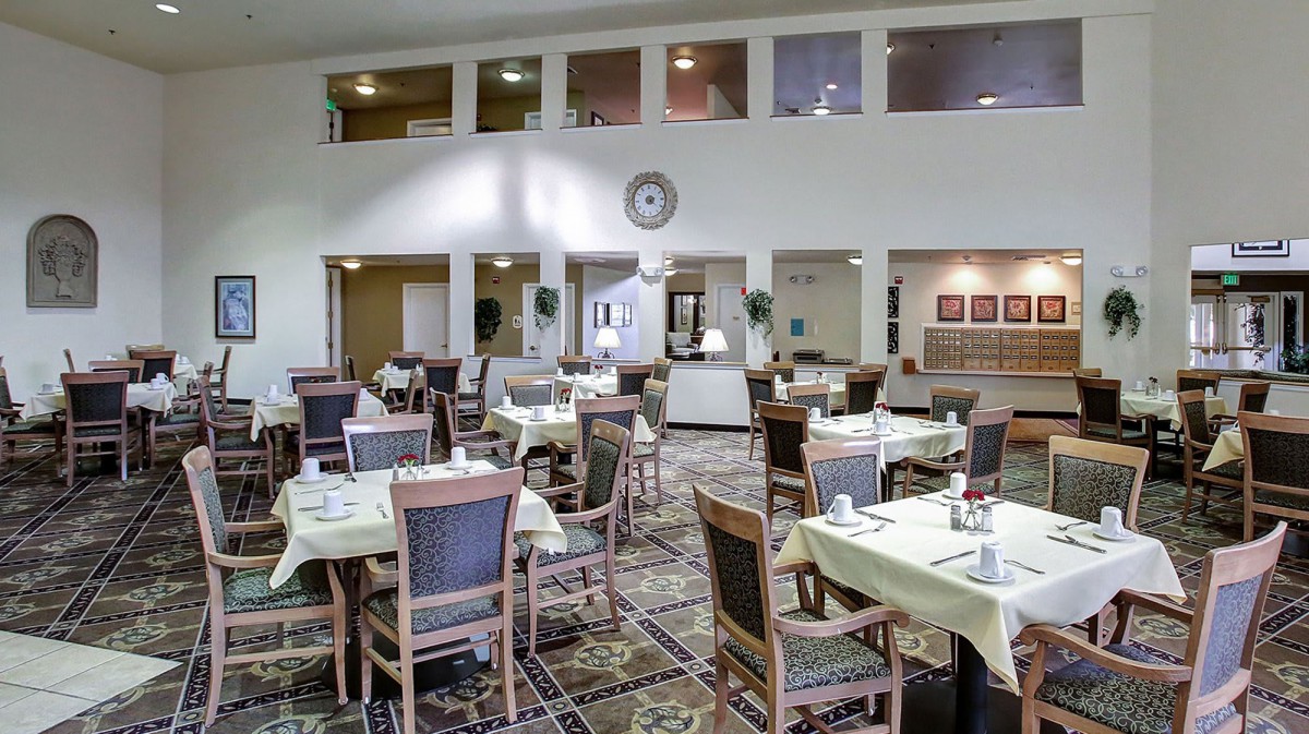 Spacious dining area with neatly arranged tables and chairs.