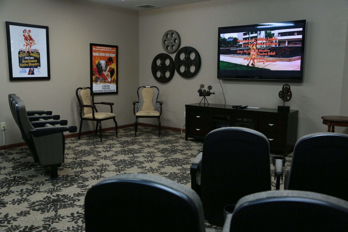 A cozy home theater setup with comfortable seating and a large television.
