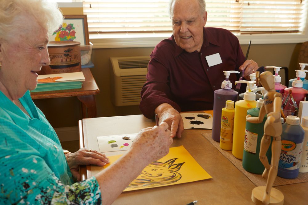 Seniors enjoying a painting session at a community center.