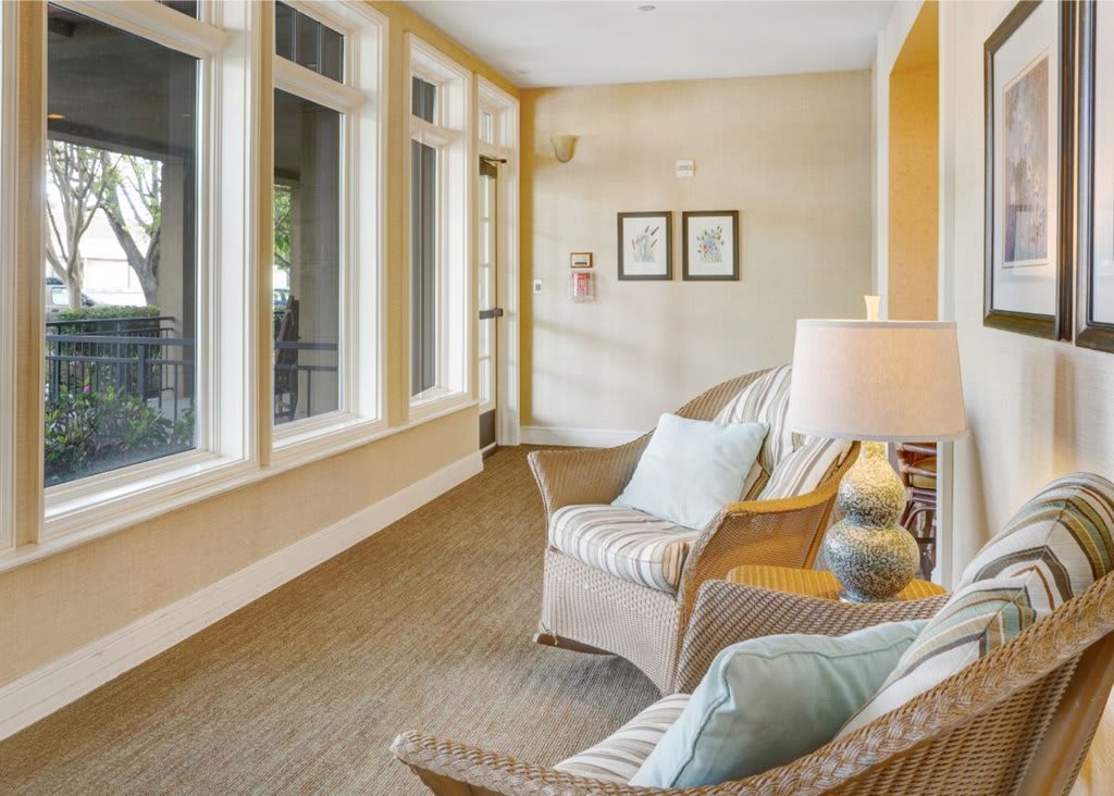 A cozy seating area with armchairs and large windows allowing natural light to fill the space.