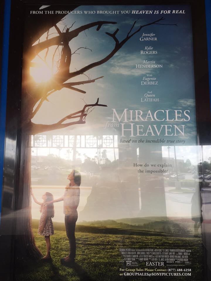 A movie poster for 'Miracles from Heaven', depicting a mother and child holding hands under a tree with the sun shining through.