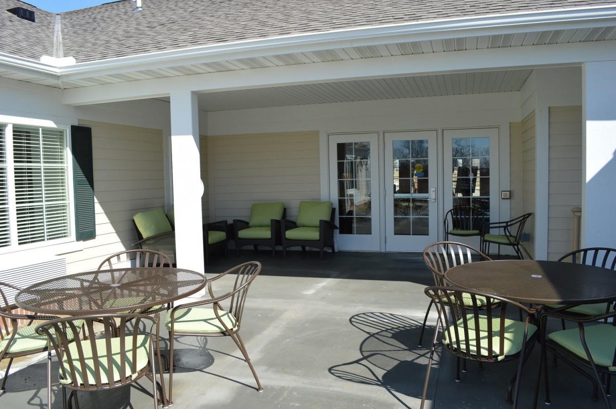 A patio area with comfortable outdoor seating and tables.