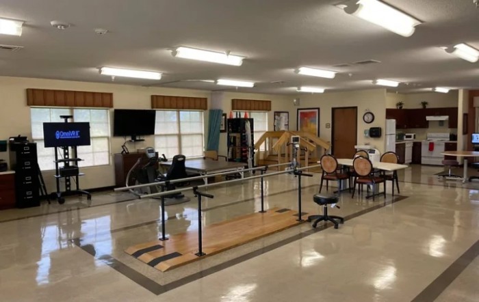 A well-equipped physical therapy center with exercise equipment and treatment areas.