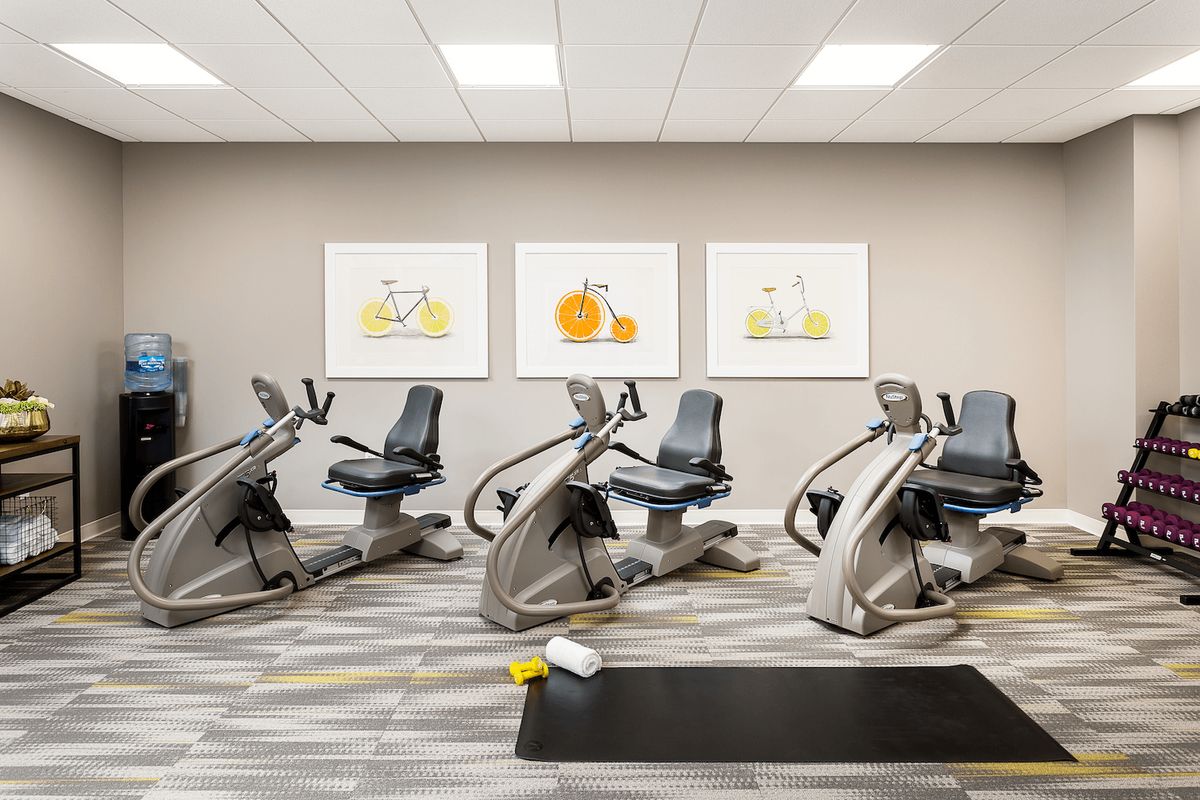 A modern gym with exercise bikes and fitness equipment.