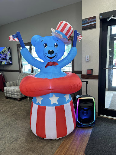 A cheerful inflatable bear celebrating a patriotic theme.
