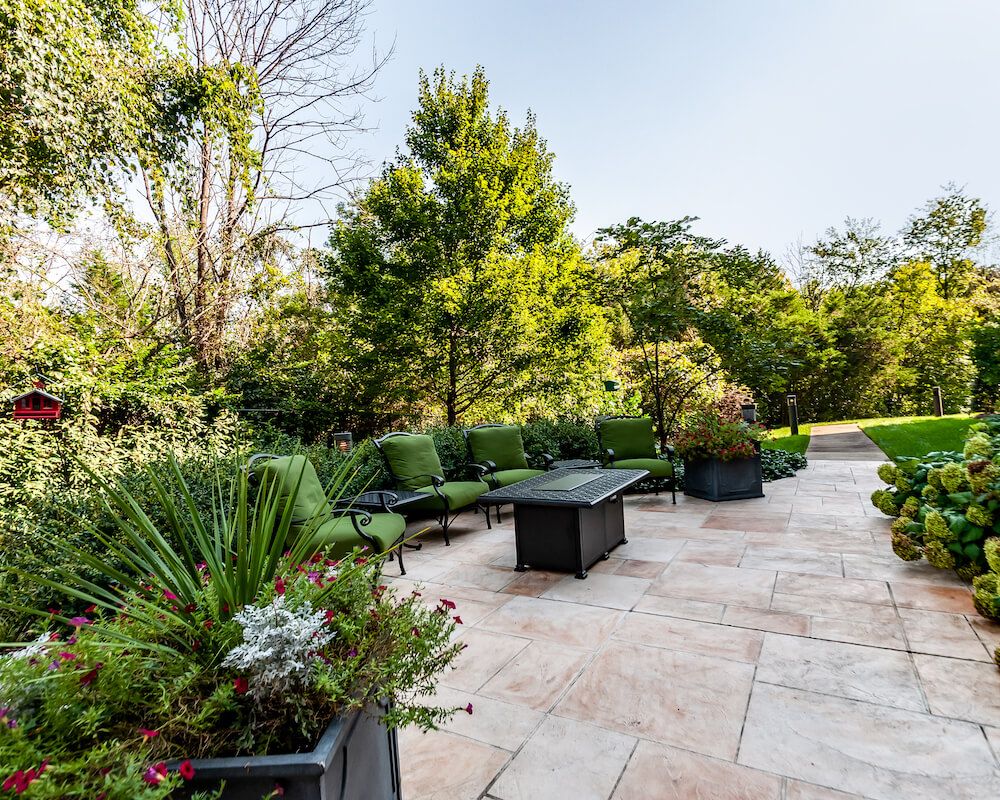 A beautifully landscaped patio garden with seating and lush greenery.