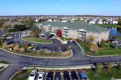 Aerial view of a suburban apartment complex with a parking lot.