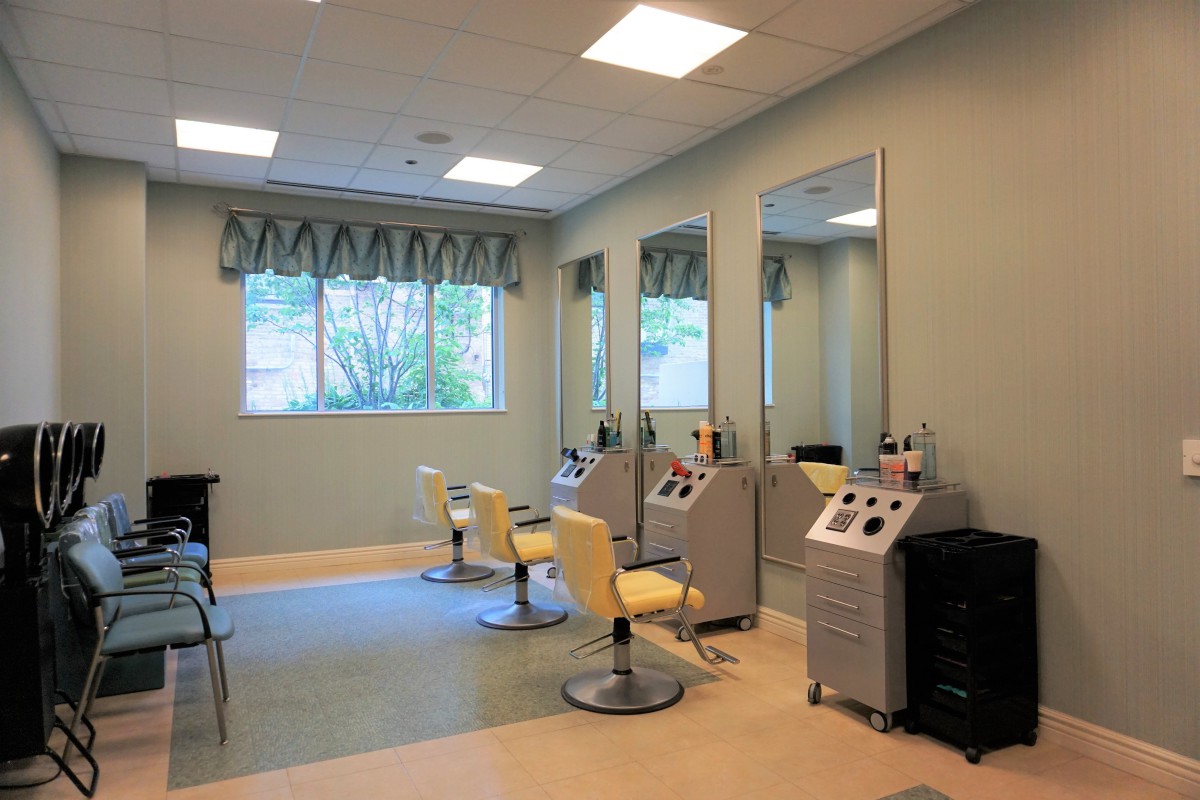 A modern hair salon interior with styling chairs and mirrors.