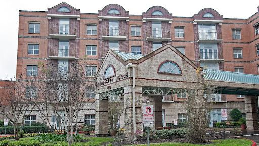 A view of a multi-story residential building with a welcoming entrance.