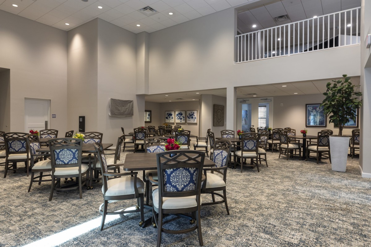 Spacious dining area with multiple tables and chairs set up for guests.
