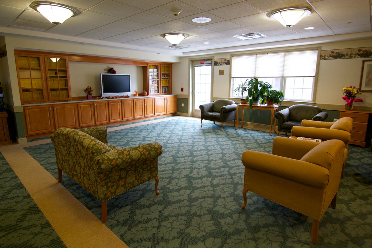 A cozy living room with multiple seating options and a large television.