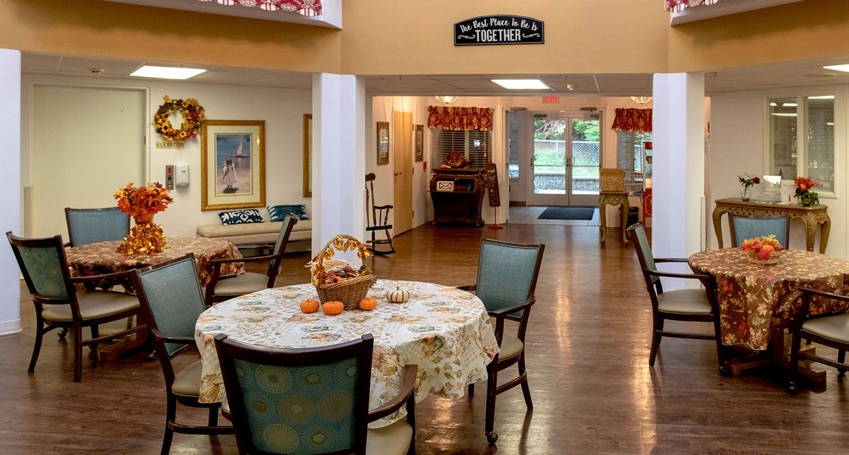 A cozy dining area with a round table and chairs, featuring a warm and inviting decor.