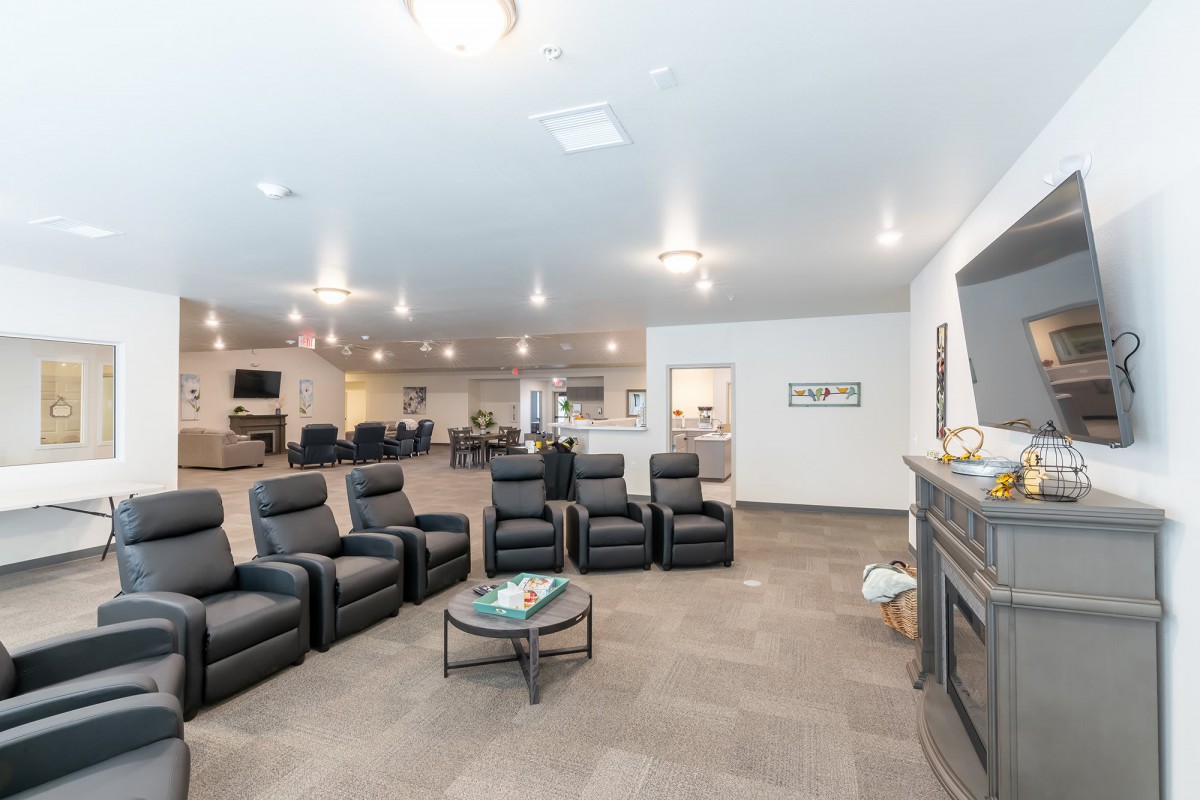 A spacious home theater room with recliner seating and modern lighting.
