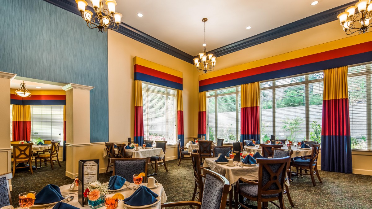Elegant dining area with colorful curtains and well-arranged tables.