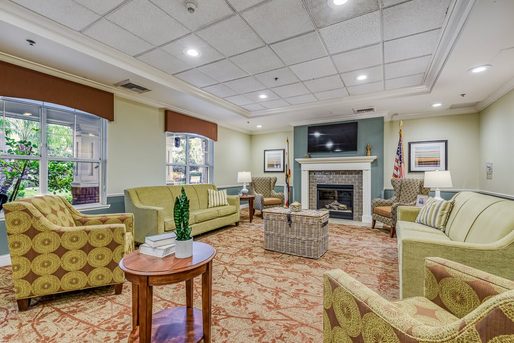 A cozy living room with comfortable seating, a fireplace, and a television.