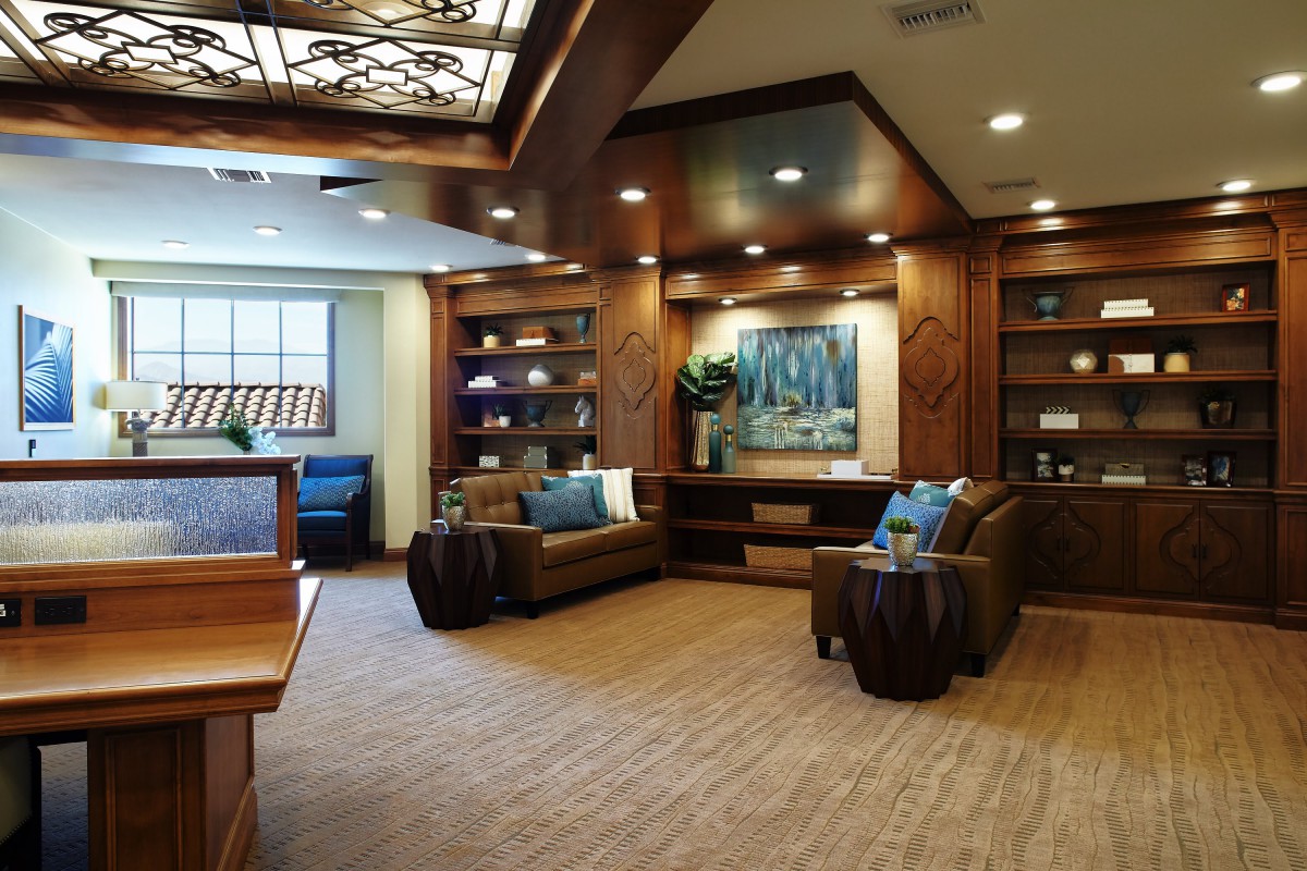 A cozy lobby area with comfortable sofas, wooden paneling, and decorative lighting.