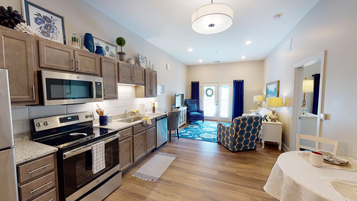 A modern open-concept kitchen and living area with stylish furniture and decor.