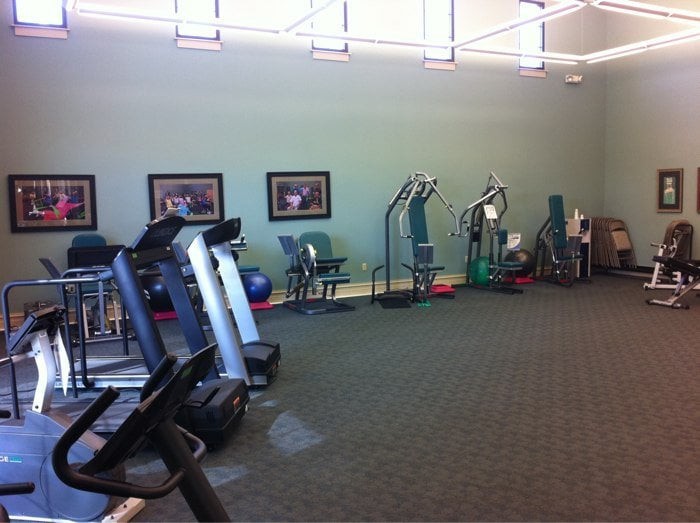 Empty gym with exercise equipment and treadmills.