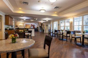 A spacious dining area with tables, chairs, and warm lighting.