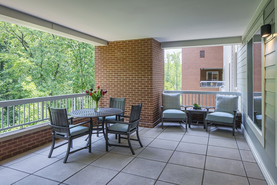 A spacious patio with outdoor seating and a nature view.