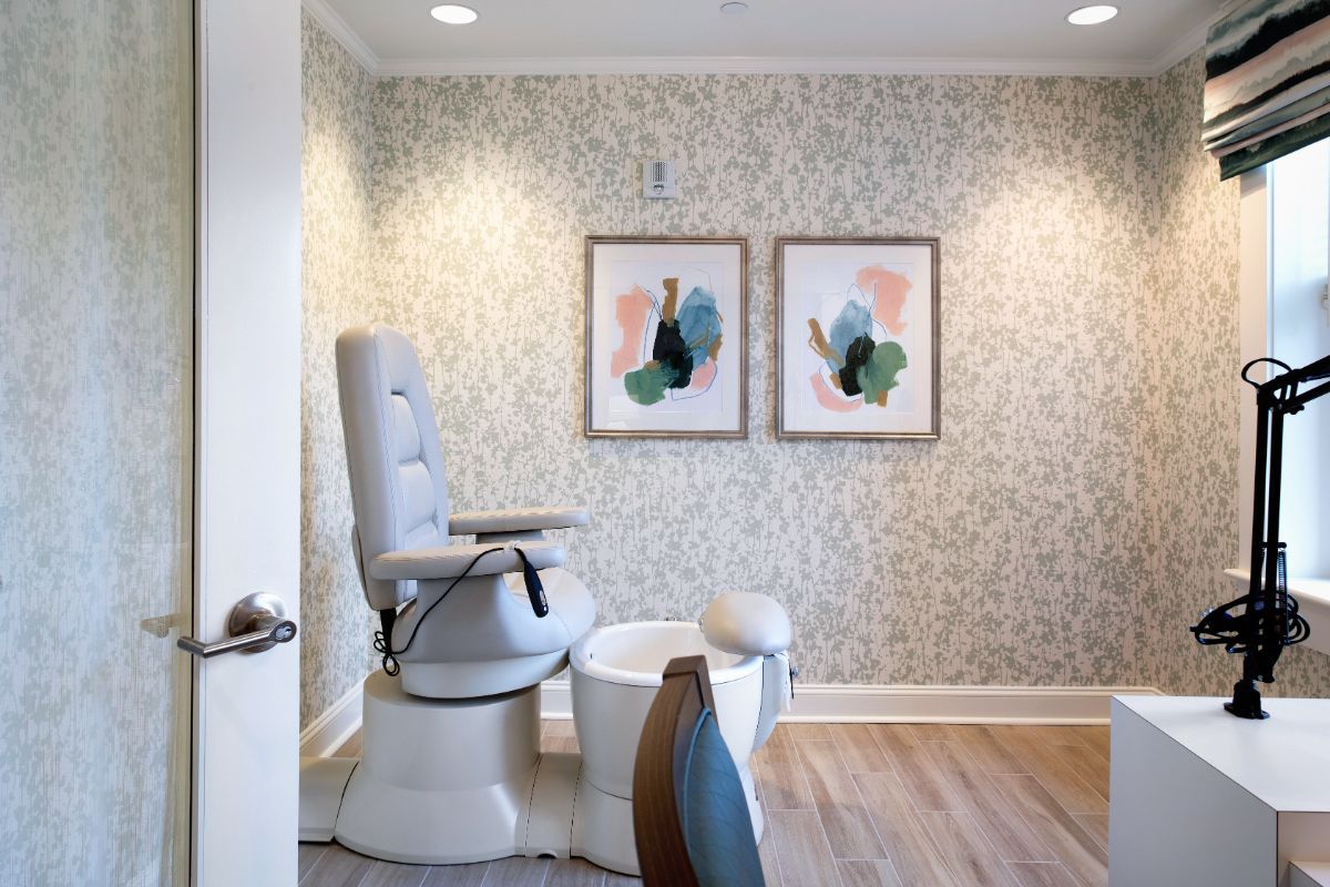 A cozy salon space featuring a pedicure chair and modern artwork on the walls.