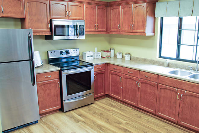 A modern kitchen with stainless steel appliances and wooden cabinets.