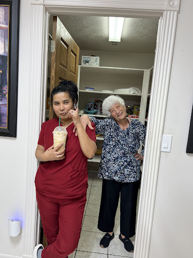 A lighthearted moment captured in an office setting with two individuals, one holding a drink.