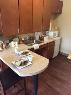 A small kitchen with a dining area set up for two.