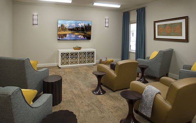 A cozy living room with comfortable seating and a large television.
