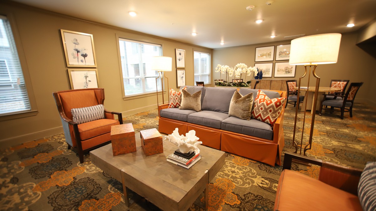 A cozy living room with stylish furniture and decorative elements.