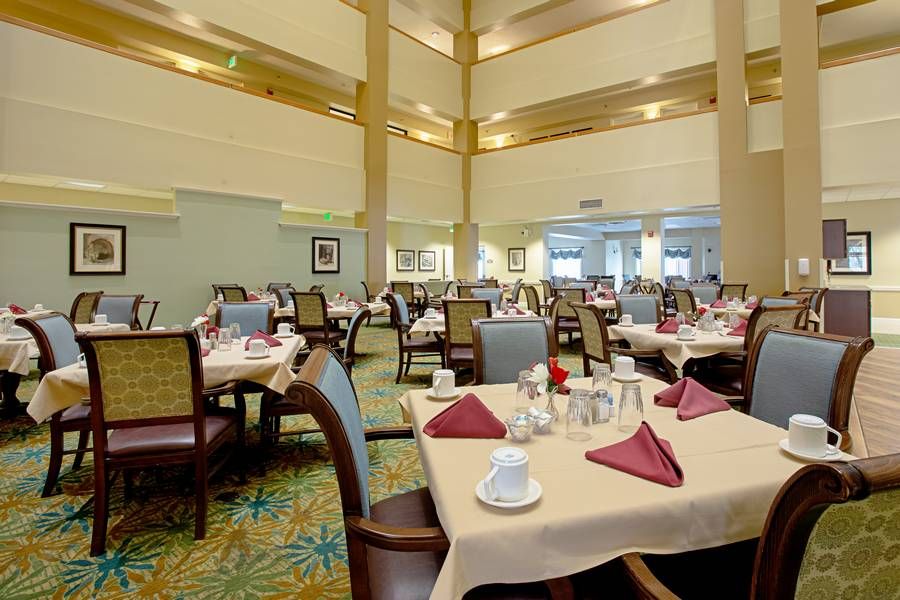 A spacious restaurant dining area with neatly set tables and chairs.