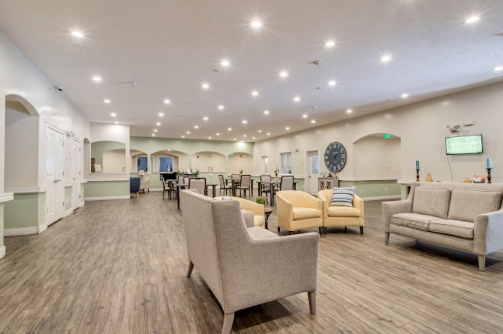 Spacious and well-lit modern lounge area with comfortable seating and tables.