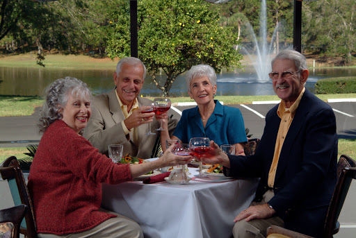 A joyful gathering of friends enjoying drinks together outdoors.