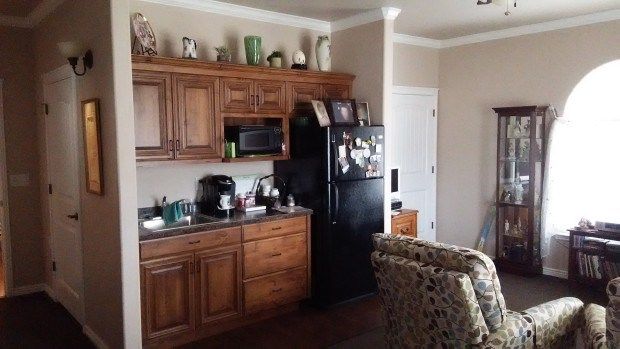 A cozy kitchen with wooden cabinets and various appliances.
