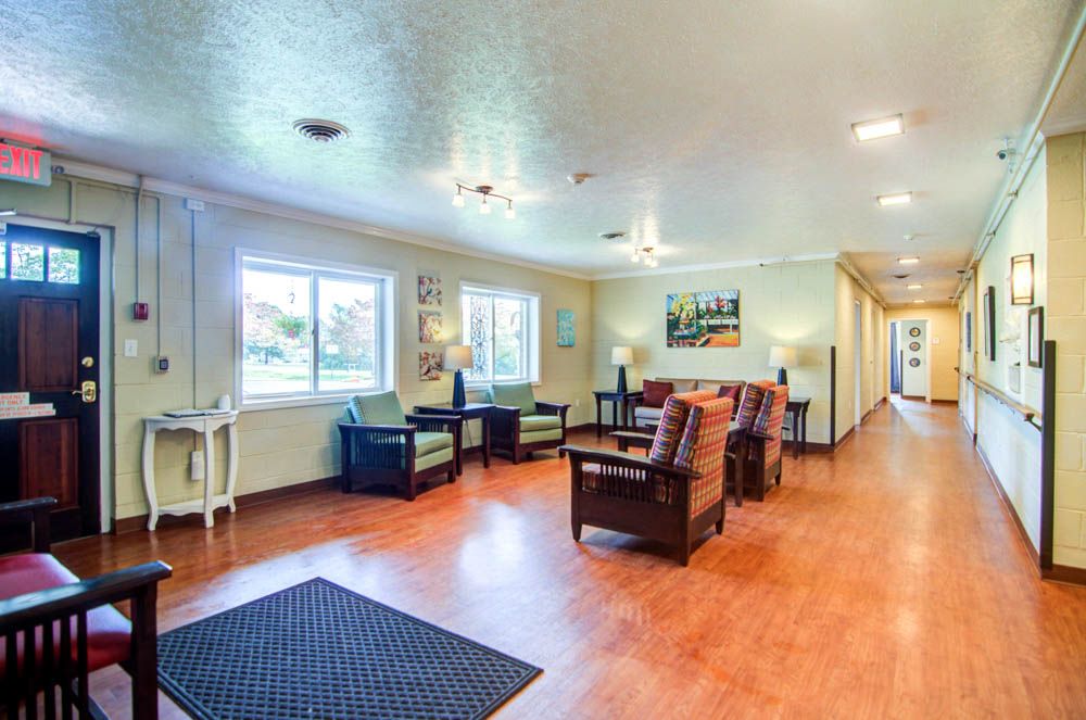 Spacious and well-lit lobby area with comfortable seating and wooden flooring.