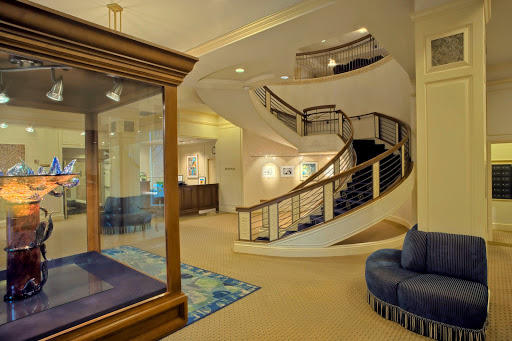 A spacious and elegantly designed lobby featuring a winding staircase and contemporary furnishings.