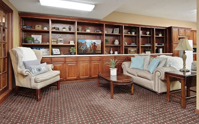 A cozy living room with comfortable seating and bookshelves.