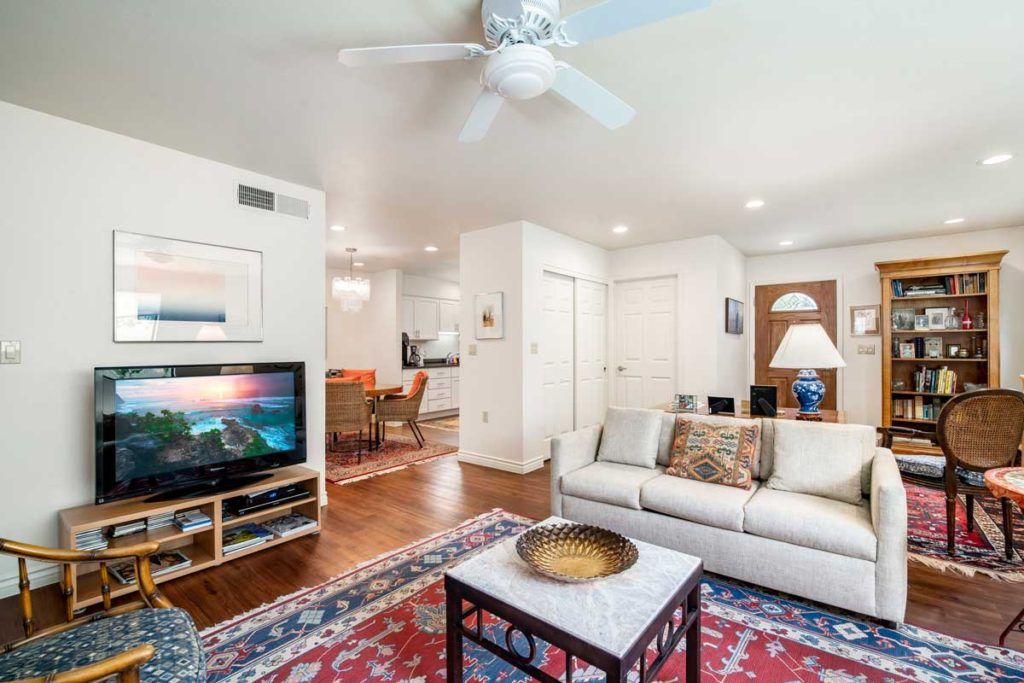 A cozy living room with a television, sofa, and decorative elements.