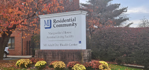 Entrance sign for Marguerite House Assisted Living Facility in a residential community.