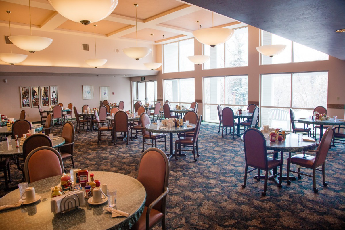 Spacious dining area with multiple tables and large windows.